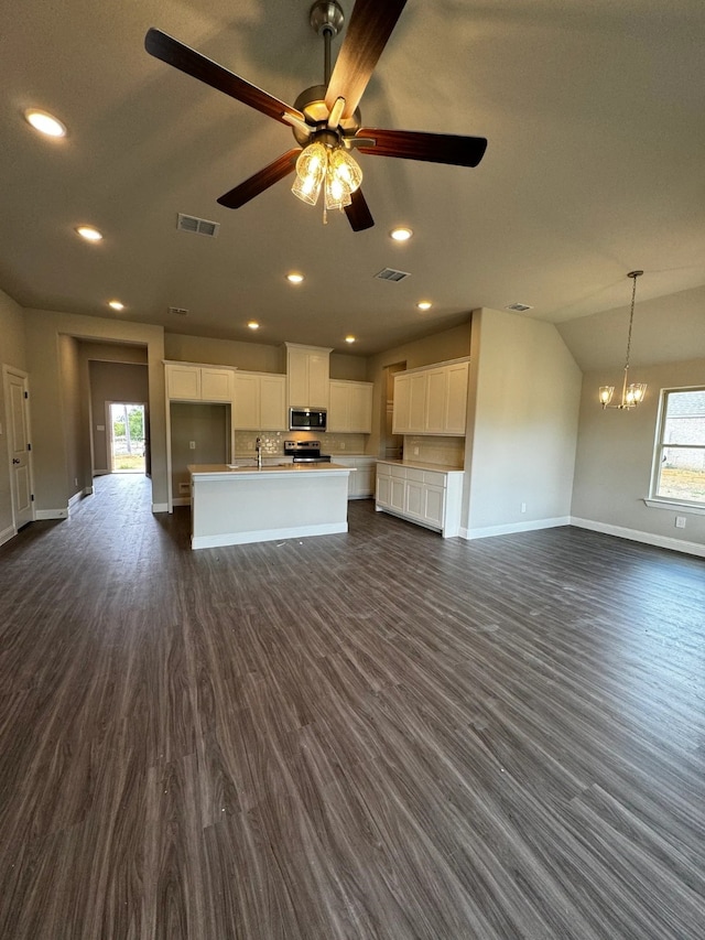 unfurnished living room featuring lofted ceiling, ceiling fan with notable chandelier, dark wood-type flooring, and sink