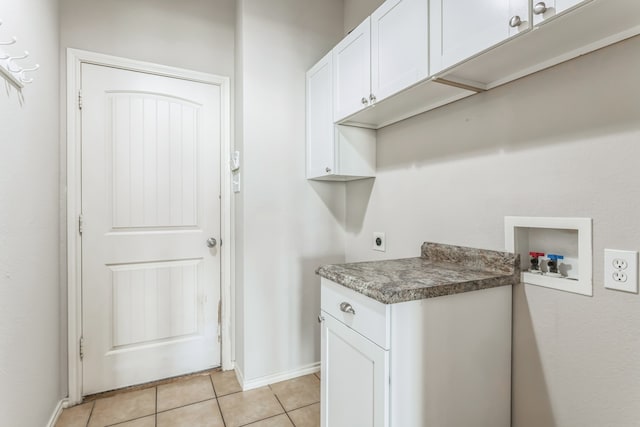 washroom featuring hookup for a washing machine, light tile patterned floors, cabinets, and hookup for an electric dryer