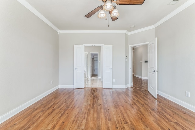 unfurnished bedroom with ceiling fan, crown molding, and light wood-type flooring