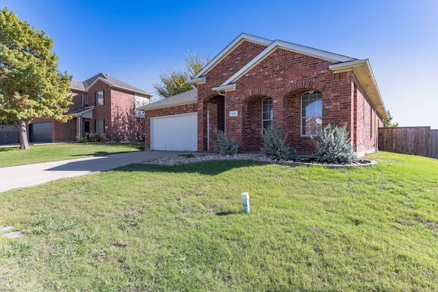 front facade featuring a garage and a front lawn