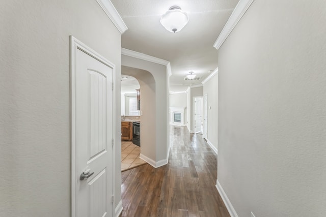 hall featuring hardwood / wood-style flooring and ornamental molding