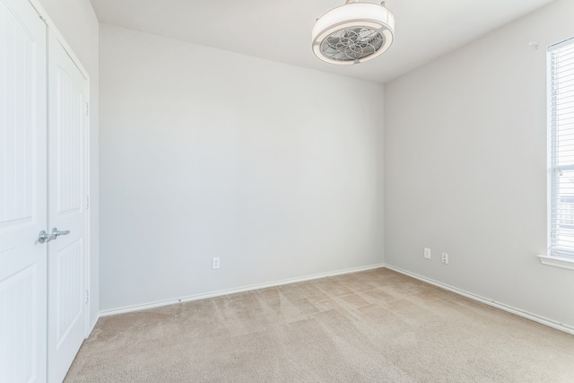 carpeted empty room with a healthy amount of sunlight