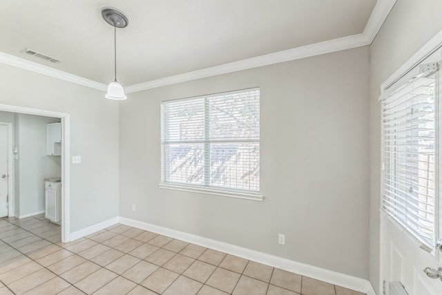 tiled spare room featuring crown molding