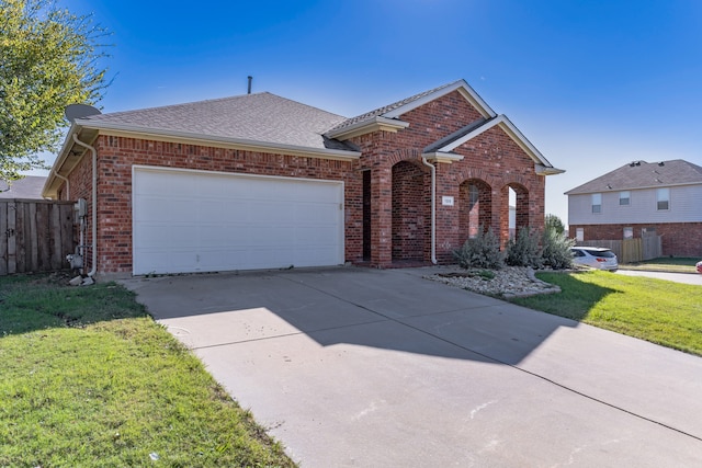 single story home featuring a garage and a front yard