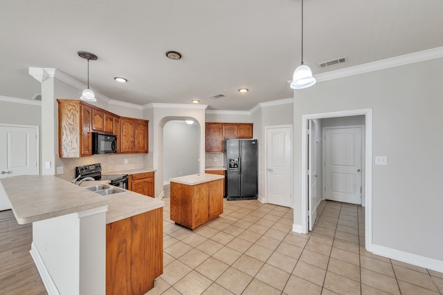 kitchen with fridge with ice dispenser, a center island, hanging light fixtures, stainless steel electric stove, and ornamental molding