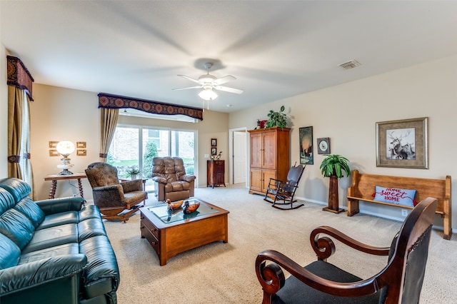 carpeted living room with ceiling fan