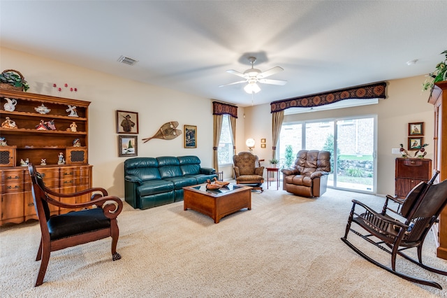 carpeted living room featuring ceiling fan