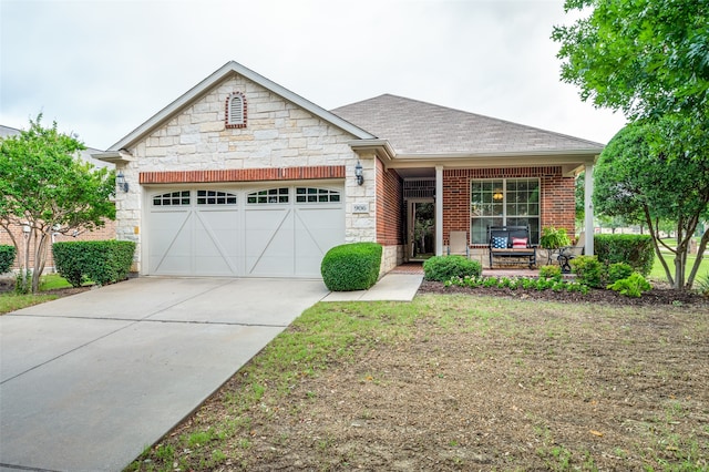 view of front of home with a porch and a garage