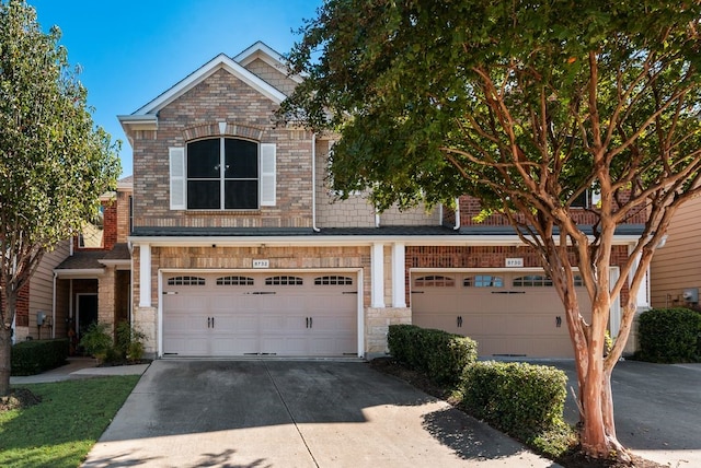 view of front of house with a garage, concrete driveway, and brick siding