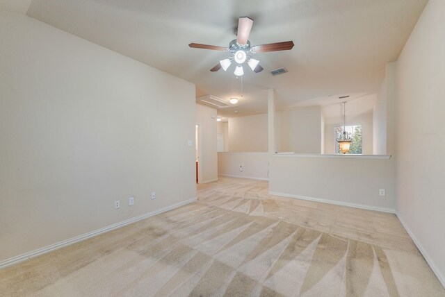 spare room with visible vents, a ceiling fan, carpet, and baseboards