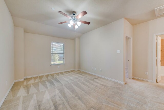 unfurnished room with light colored carpet, baseboards, ceiling fan, and visible vents