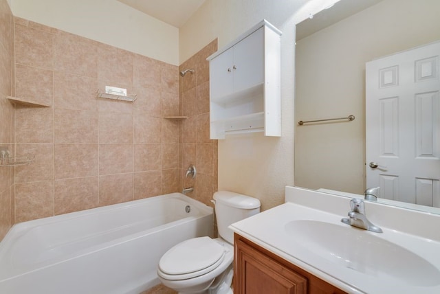 full bathroom featuring vanity, tiled shower / bath combo, and toilet