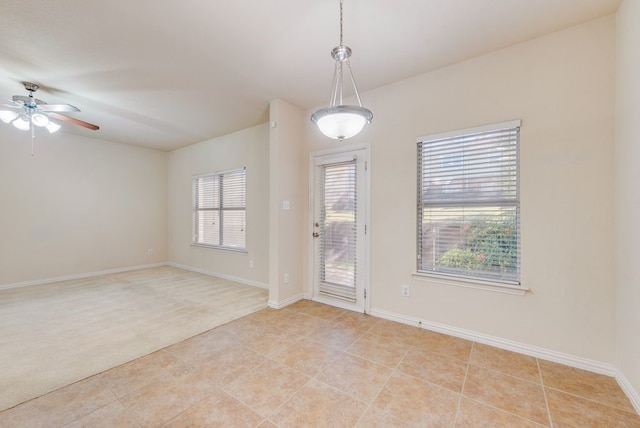 spare room featuring light tile patterned floors and ceiling fan