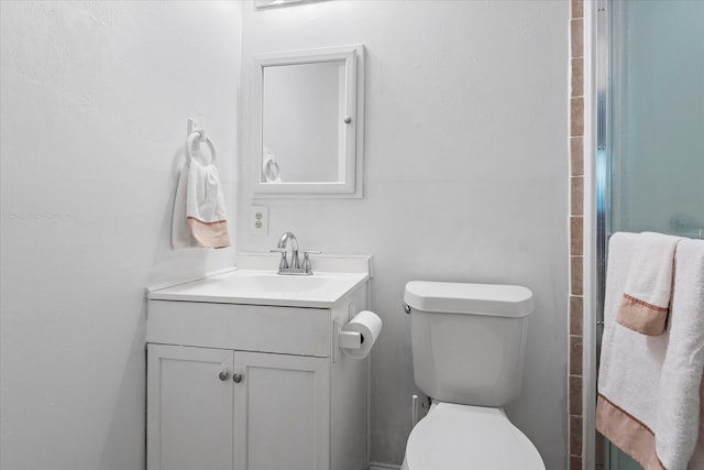 bathroom featuring vanity, toilet, and an enclosed shower