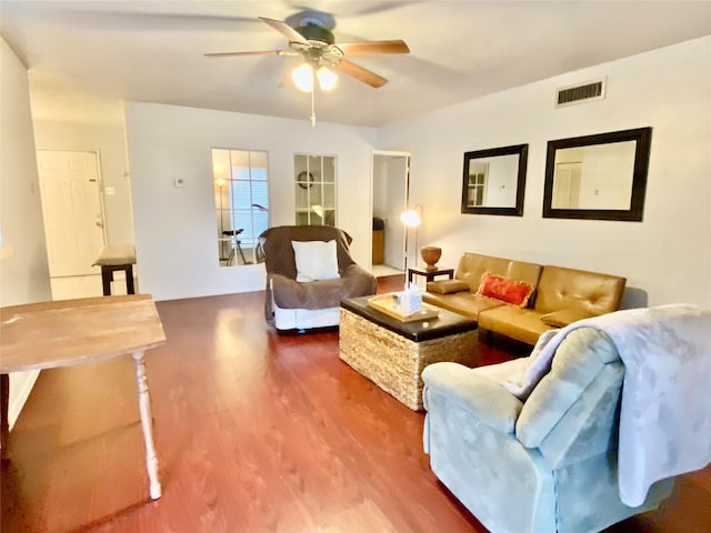 living room with ceiling fan and wood-type flooring