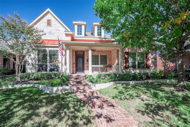 view of front of property featuring covered porch and a front yard