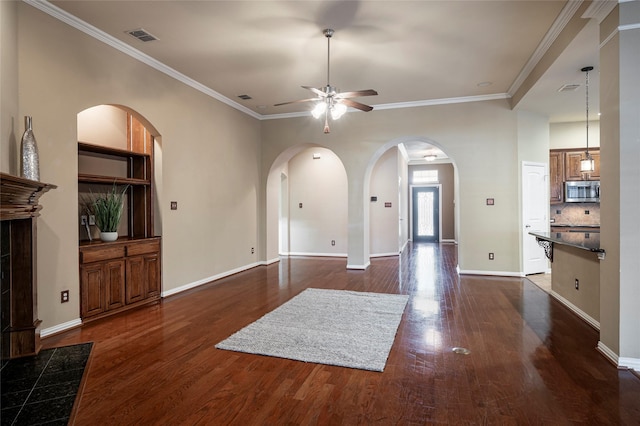 living room featuring dark wood-type flooring, ceiling fan, and ornamental molding