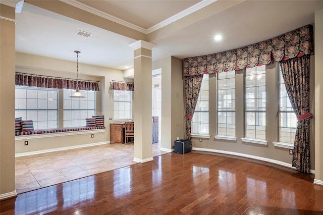 interior space with decorative columns, crown molding, and wood-type flooring