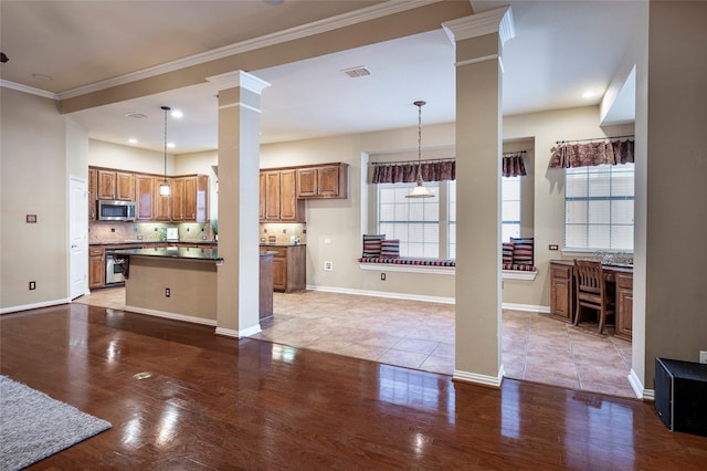 kitchen with pendant lighting, light wood-type flooring, ornamental molding, and backsplash