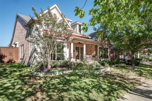 obstructed view of property with a front lawn and covered porch