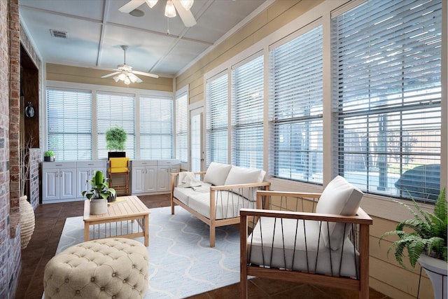 sunroom / solarium with ceiling fan and a healthy amount of sunlight