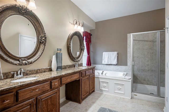 bathroom featuring shower with separate bathtub, vanity, and tile patterned floors