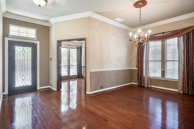 entrance foyer featuring french doors, dark hardwood / wood-style flooring, ornamental molding, and a notable chandelier