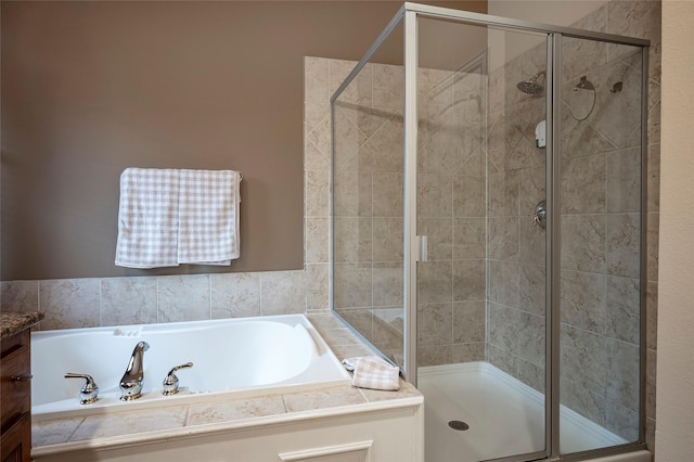 bathroom featuring separate shower and tub