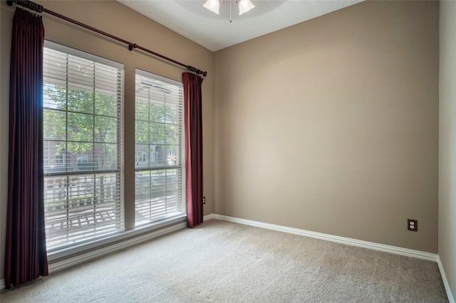 empty room with carpet floors and ceiling fan