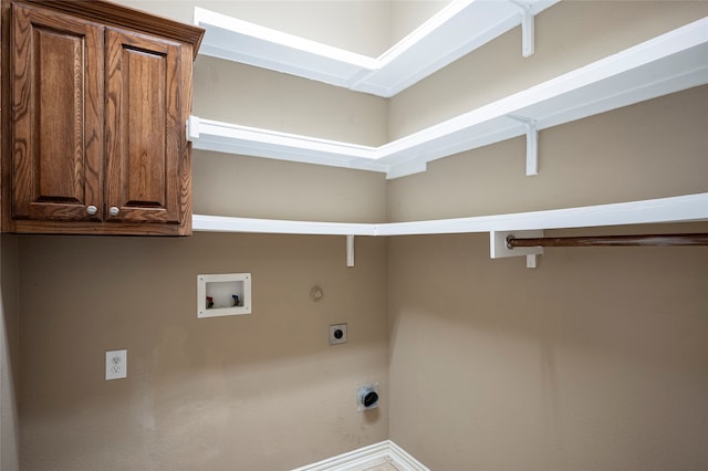 laundry area with hookup for an electric dryer, washer hookup, hookup for a gas dryer, and cabinets