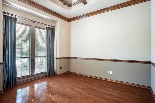 unfurnished room with crown molding, ceiling fan, and dark wood-type flooring