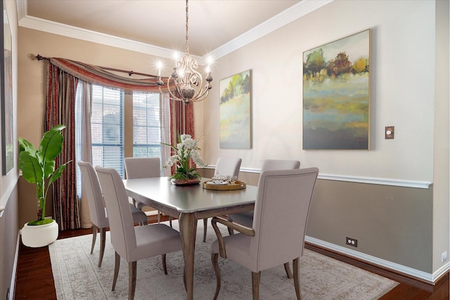 dining space featuring a chandelier, dark wood-type flooring, and ornamental molding