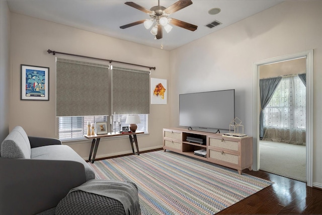 living room with ceiling fan and wood-type flooring