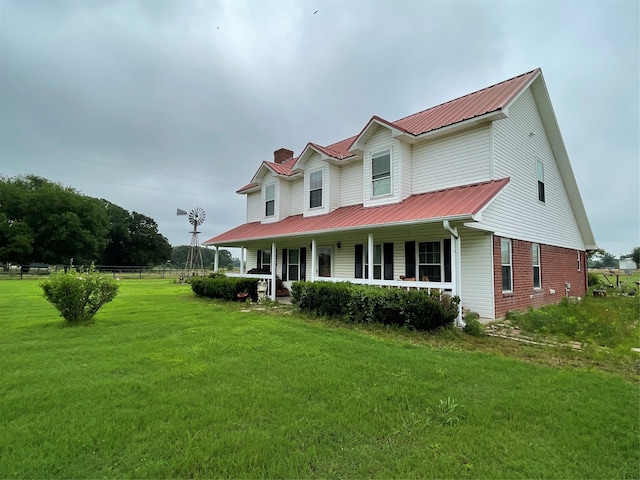 view of front of house featuring covered porch and a front lawn