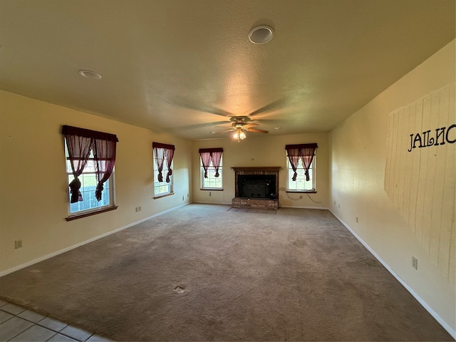 unfurnished living room featuring a textured ceiling, carpet floors, and ceiling fan