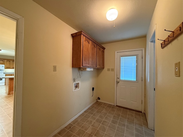 clothes washing area with washer hookup, electric dryer hookup, cabinets, and a textured ceiling