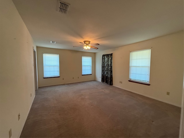 carpeted spare room with ceiling fan