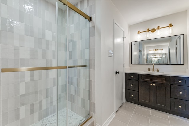 bathroom with tile patterned flooring, vanity, and walk in shower