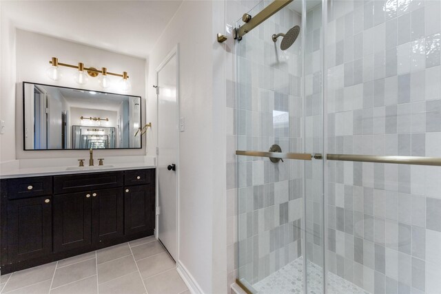 bathroom with tile patterned floors, vanity, and an enclosed shower