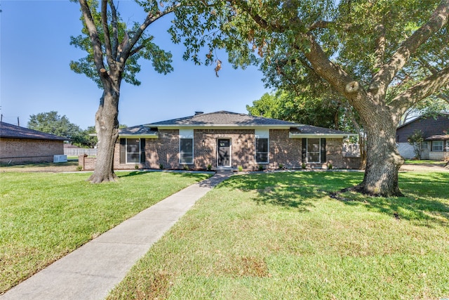 ranch-style home with a front lawn