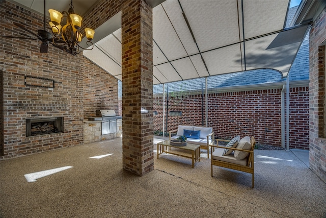 view of patio / terrace with an outdoor brick fireplace, an outdoor kitchen, and a grill