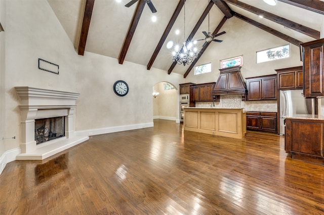 kitchen featuring premium range hood, high vaulted ceiling, appliances with stainless steel finishes, and ceiling fan with notable chandelier