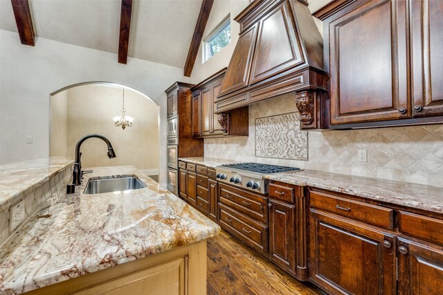 kitchen featuring appliances with stainless steel finishes, sink, custom exhaust hood, and backsplash