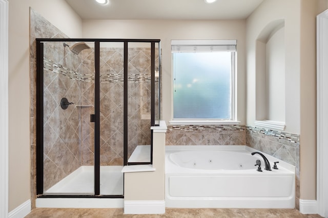 bathroom featuring separate shower and tub