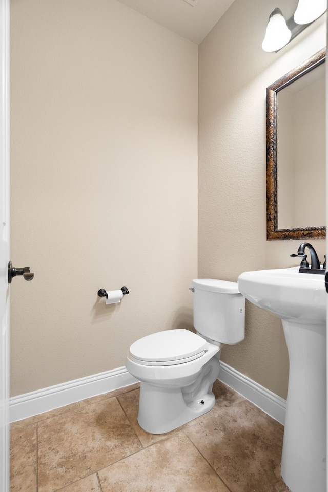 bathroom featuring tile patterned floors and toilet