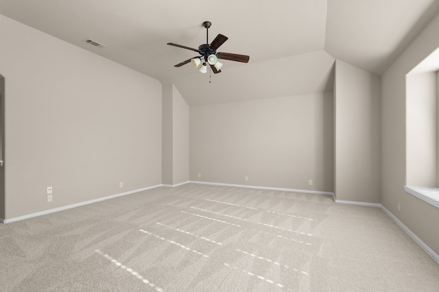 unfurnished room with light carpet, vaulted ceiling, and ceiling fan