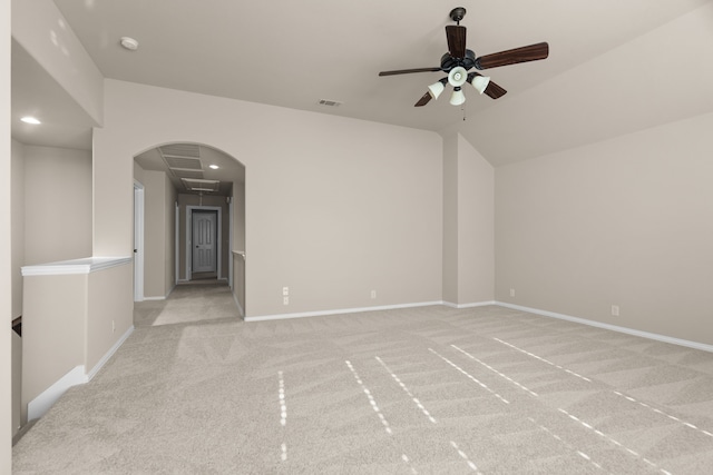 unfurnished room with ceiling fan, light colored carpet, and lofted ceiling