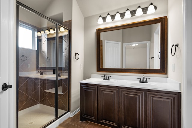 bathroom featuring tile patterned floors, vanity, and a shower with door