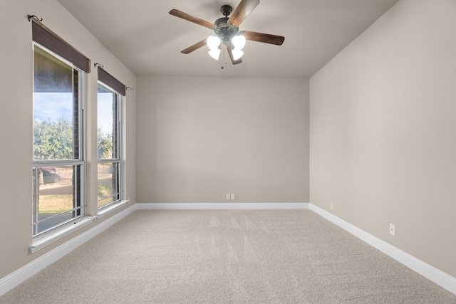 carpeted spare room with ceiling fan