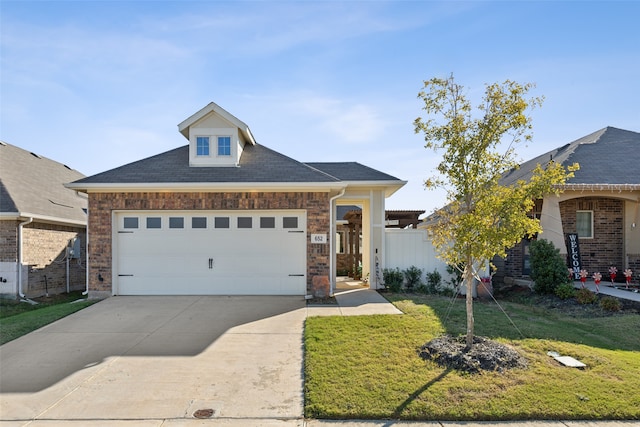 view of front of home featuring a garage and a front lawn